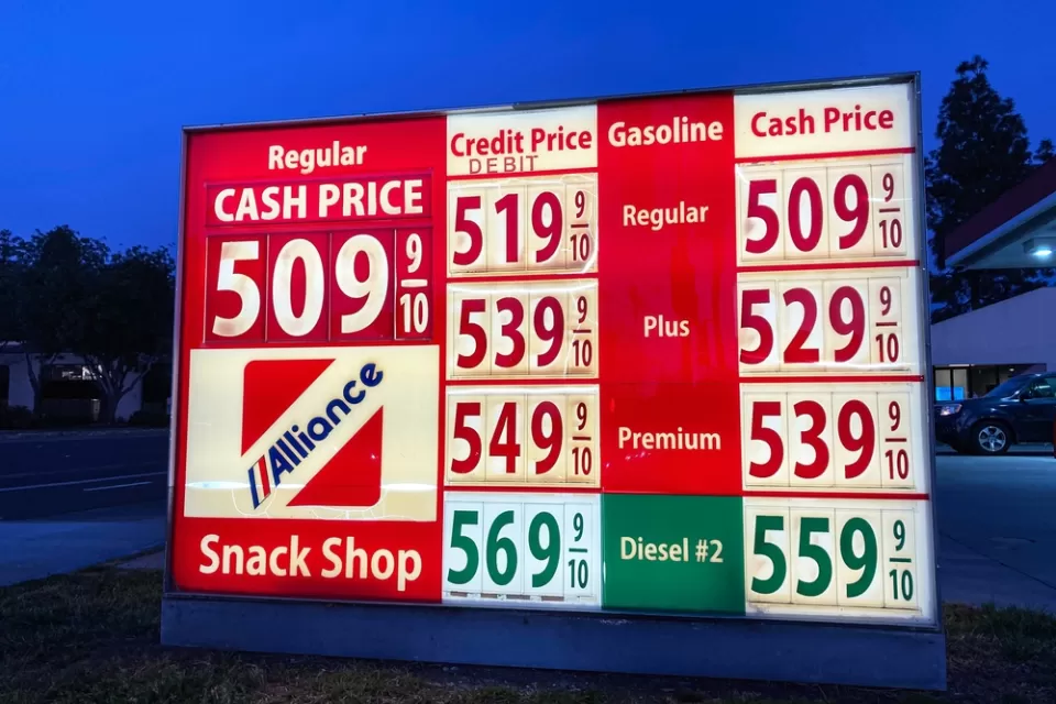 A sign showing gas prices, all at more than $5 a gallon.